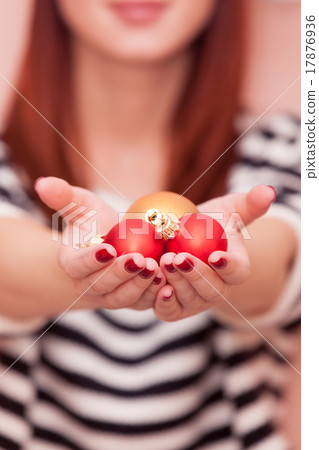 girl showing Christmas baubles girl showing Christmas baubles 17876936