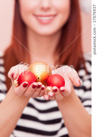 girl showing Christmas baubles 17876937
