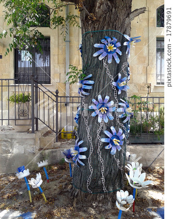 Tree decorated with plastic flowers Tree decorated with plastic flowers 17879691