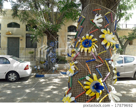 Tree decorated with yellow plastic flowers Tree decorated with yellow plastic flowers 17879692