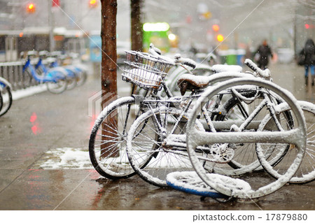 Snow covered bicycles in New York 17879880