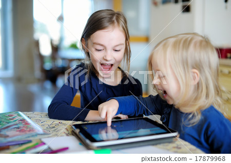 Two little sisters playing with a digital tablet 17879968