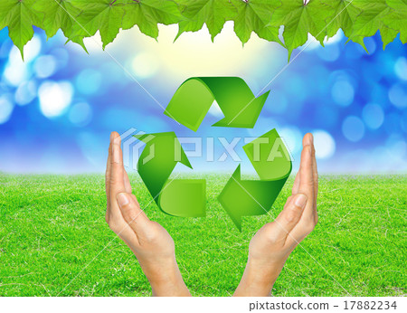 RECYCLE sign in hands against green spring. RECYCLE sign in hands against green spring. 17882234