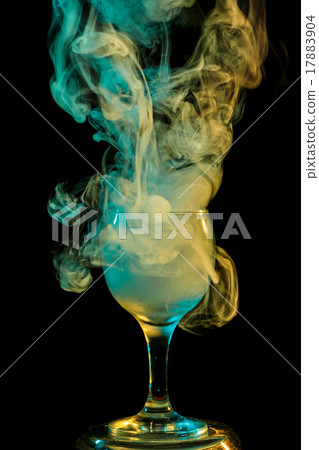 Yellow-green smoke in a glass. Halloween. Yellow-green smoke in a glass. Halloween. 17883904