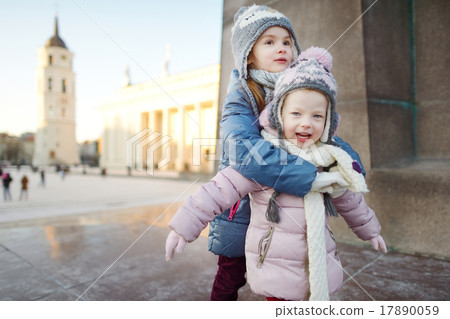 Two funny adorable little sisters outdoors in winter Two funny adorable little sisters outdoors in winter 17890059