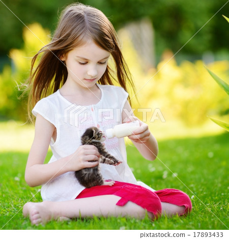 Llittle girl feeding small kitten with milk 17893433