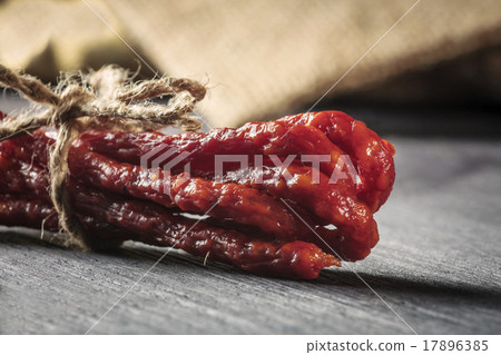 dried sausages on wooden cutting board 17896385