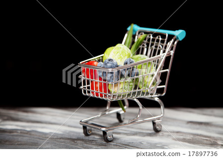 Shopping cart with vegetables on black background Shopping cart with vegetables on black background 17897736