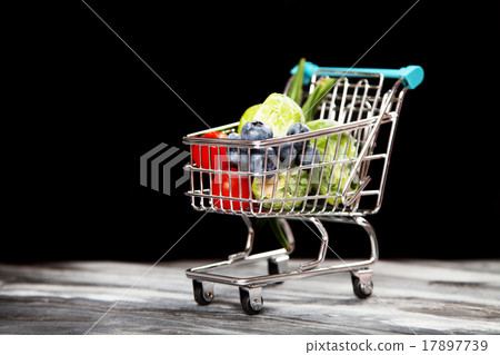 Shopping cart with vegetables on black background 17897739