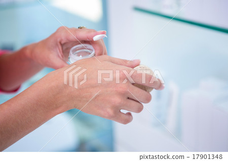 Woman sampling a face cream Woman sampling a face cream 17901348