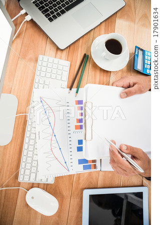 Businessman working on wooden desk Businessman working on wooden desk 17901634