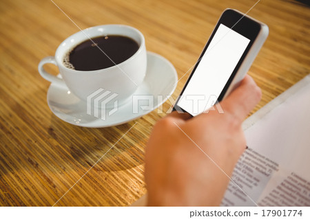 Man using smartphone and having coffee 17901774