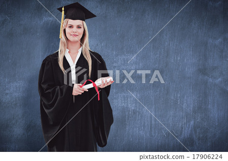 Composite image of blonde student in graduate robe holding her d 17906224