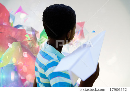 Composite image of cute little boy with paper airplane Composite image of cute little boy with paper airplane 17906352