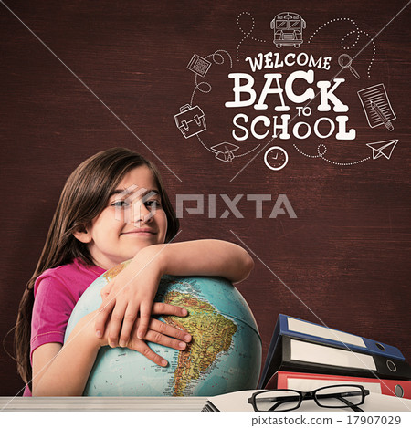 Composite image of cute pupil smiling holding globe Composite image of cute pupil smiling holding globe 17907029