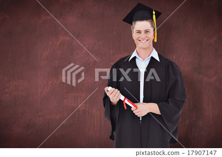 Composite image of a male graduate with his degree in hand Composite image of a male graduate with his degree in hand 17907147