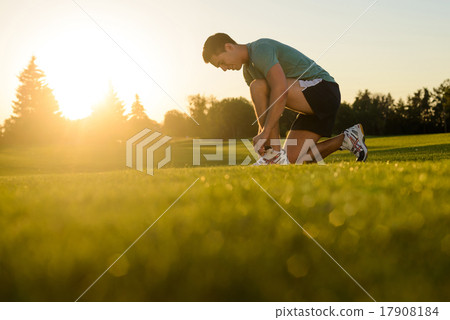 Guy tying shoelaces on sneakers. Guy tying shoelaces on sneakers. 17908184