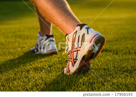 Stock Photo: Running shoes close up on grass.