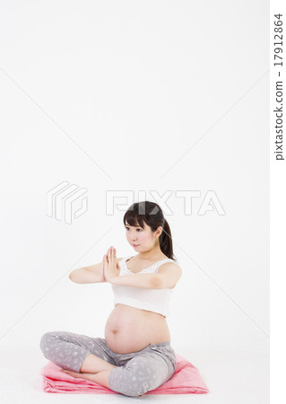 Pregnant Woman Sitting On The Floor In Front Of Stock Photo