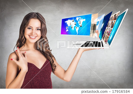 Young woman holds laptop Young woman holds laptop 17916584