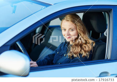 Young confident woman driving a car 17916733