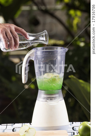 Chef pouring water to the Blender Chef pouring water to the Blender 17916786