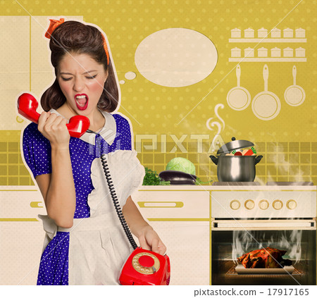 Angry housewife shouting on the phone in the kitchen 17917165