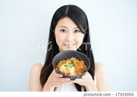 A woman eats pork cutlet A woman eats pork cutlet 17928008