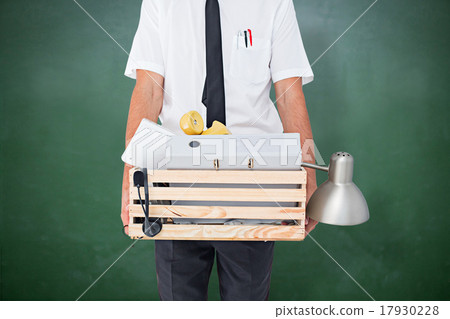 Composite image of fired businessman holding box of belongings Composite image of fired businessman holding box of belongings 17930228