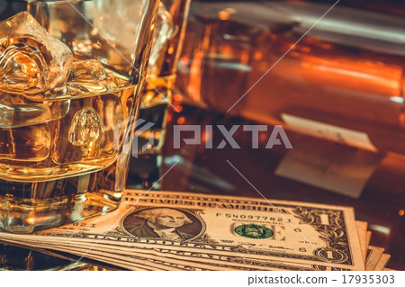close-up of glasses of whiskey near bottle 17935303
