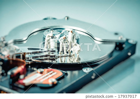 Group of criminalists inspecting hard drive 17937017