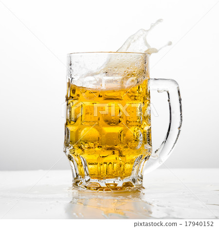 Beer splashing in glasses on white 17940152