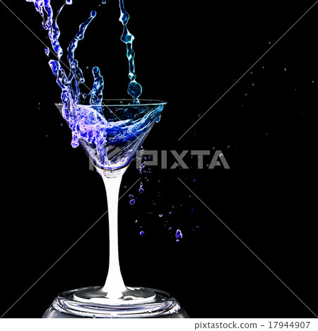 Cocktail glass with splashes on a black background Cocktail glass with splashes on a black background 17944907