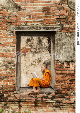 Novice monk reading  books in ruins. 17946579