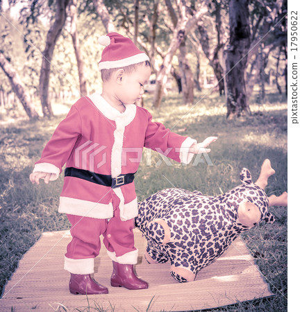 A kid in Santaclaus suit push reindeer doll away , unfriend conc A kid in Santaclaus suit push reindeer doll away , unfriend conc 17950622