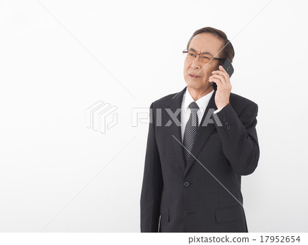 Senior businessman who speaks with anger on smartphone 17952654