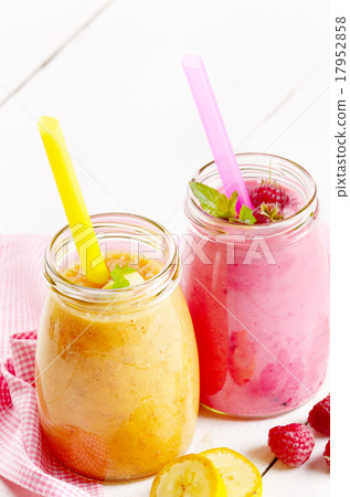 Carrot banana and raspberry shake on wooden table 17952858