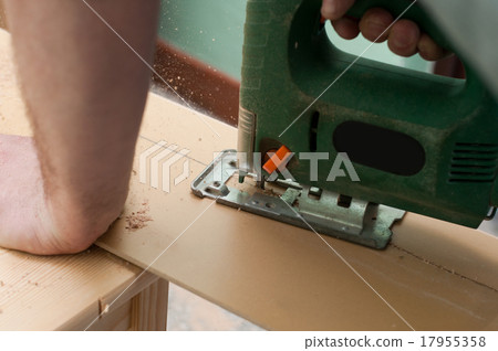 jigsaw cutting sheets on a wooden plank 17955358
