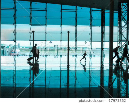 People with luggage walking at airport  17973862