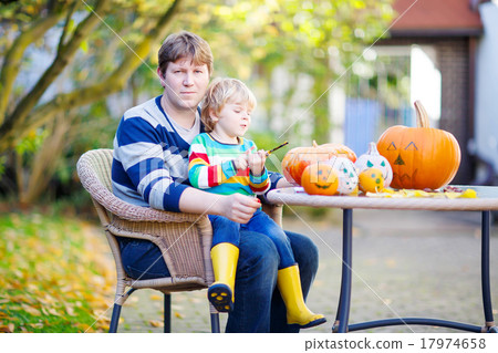little child and his father making jack-o-lantern for halloween little child and his father making jack-o-lantern for halloween 17974658