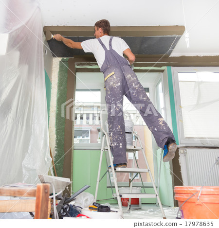 Plasterer renovating indoor walls and ceilings. 17978635
