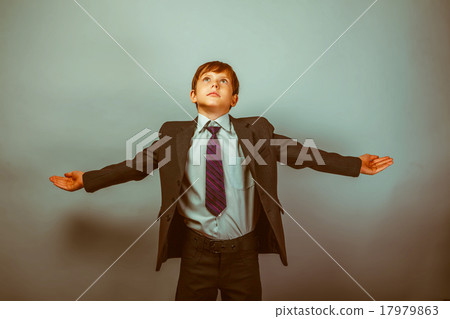 Teen boy businessman spread his arms look up Teen boy businessman spread his arms look up 17979863
