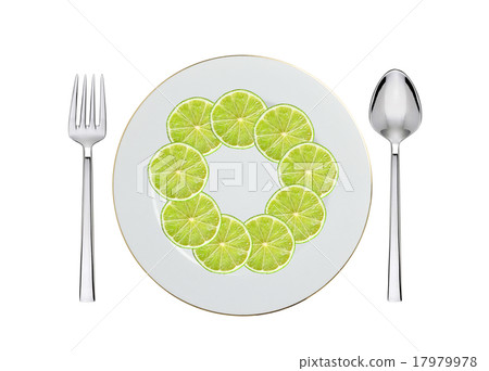 lime slices on plate, spoon and fork on white 17979978