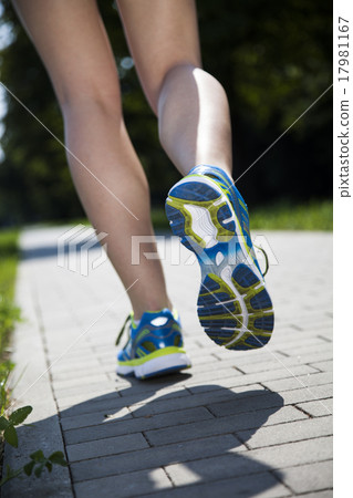 Runner feet running on road closeup on shoe Runner feet running on road closeup on shoe 17981167