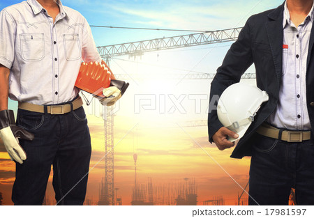 Stock Photo: two engineer man working with white safety helmet