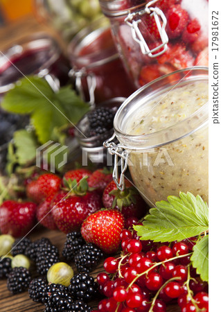 Glass of mixed berry jam with strawberries 17981672