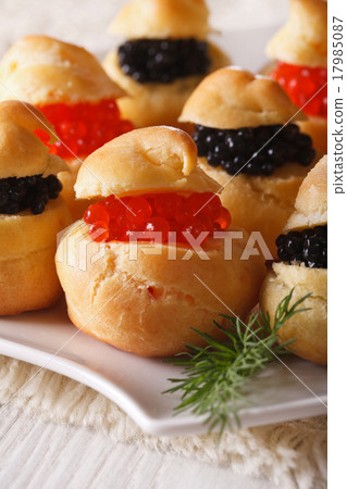 Delicious profiteroles with red and black caviar Delicious profiteroles with red and black caviar 17985087