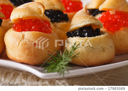 Fresh profiteroles with red and black caviar macro 17985089