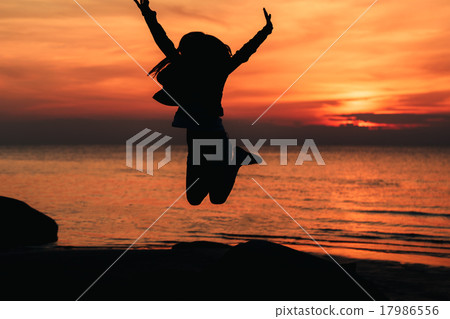 silhouette jumping girl against the backdrop of a silhouette jumping girl against the backdrop of a 17986556