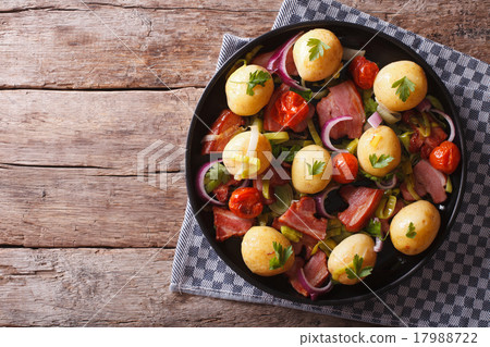 New potatoes with bacon on a plate in a rustic New potatoes with bacon on a plate in a rustic 17988722